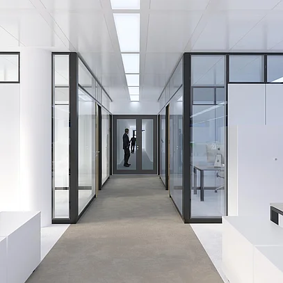 View of the hallway, with Goldbach Kirchner T65 partition walls on the right and left, featuring structural glazing and black profiles