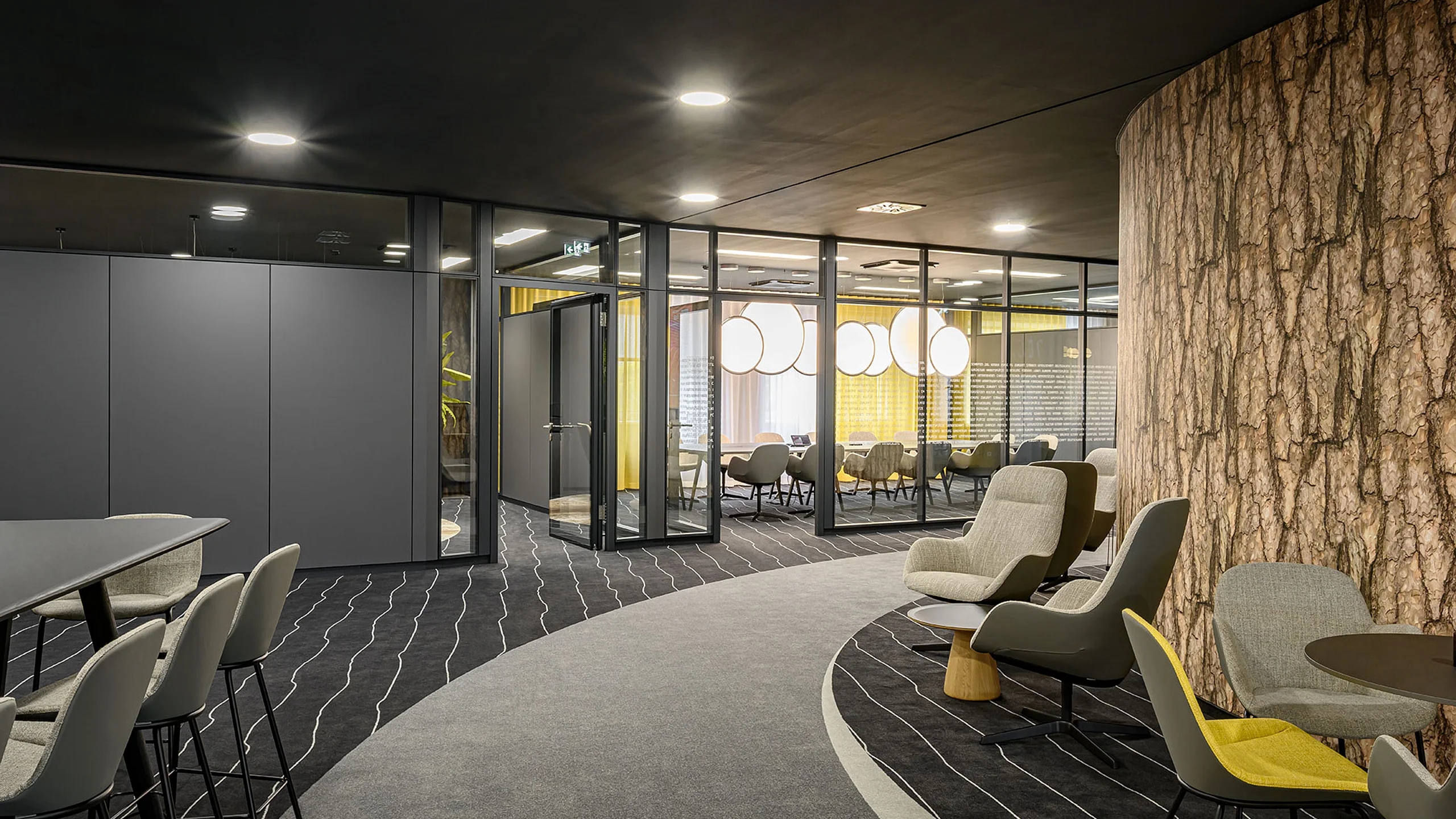 View of a meeting room with transparent glass partition walls; the adjacent room is designed with opaque solid T10 partition walls.